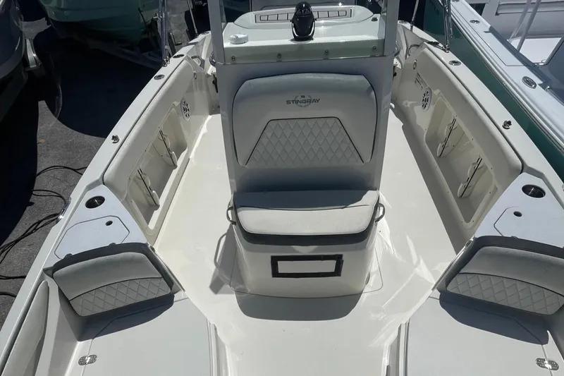 Slide: The Image of 2020 Stingray 206 CC boat interior with cushioned seating and storage compartments. - 6