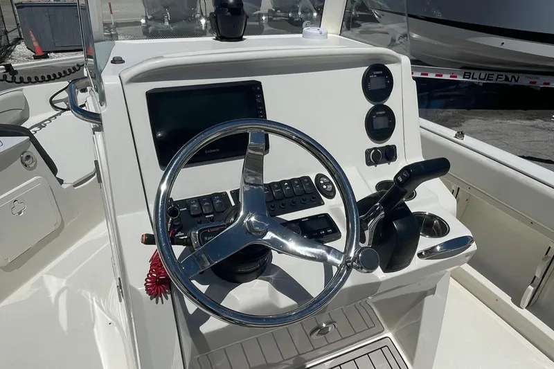 Slide: The Image of 2020 Stingray 206 CC boat dashboard with steering wheel and control panel. - 8