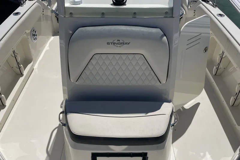 Slide: The Image of 2020 Stingray 206 CC boat interior with cushioned seating and storage compartments. - 9