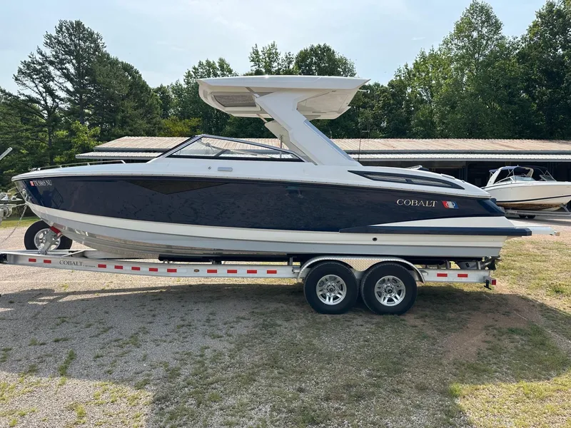 Slide: The Image of 2022 Cobalt A29 boat on a trailer, side view, outdoors. - 1