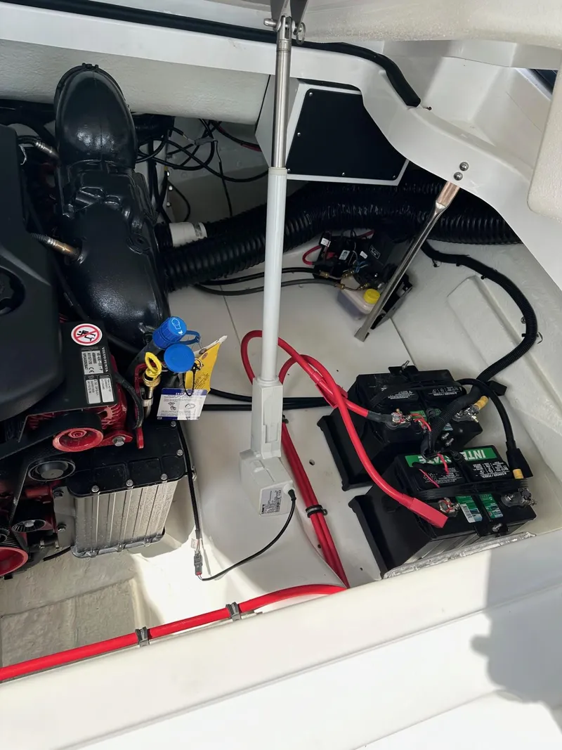Slide: The Image of Engine compartment of a 2022 Cobalt A29 boat with visible battery and wiring. - 13