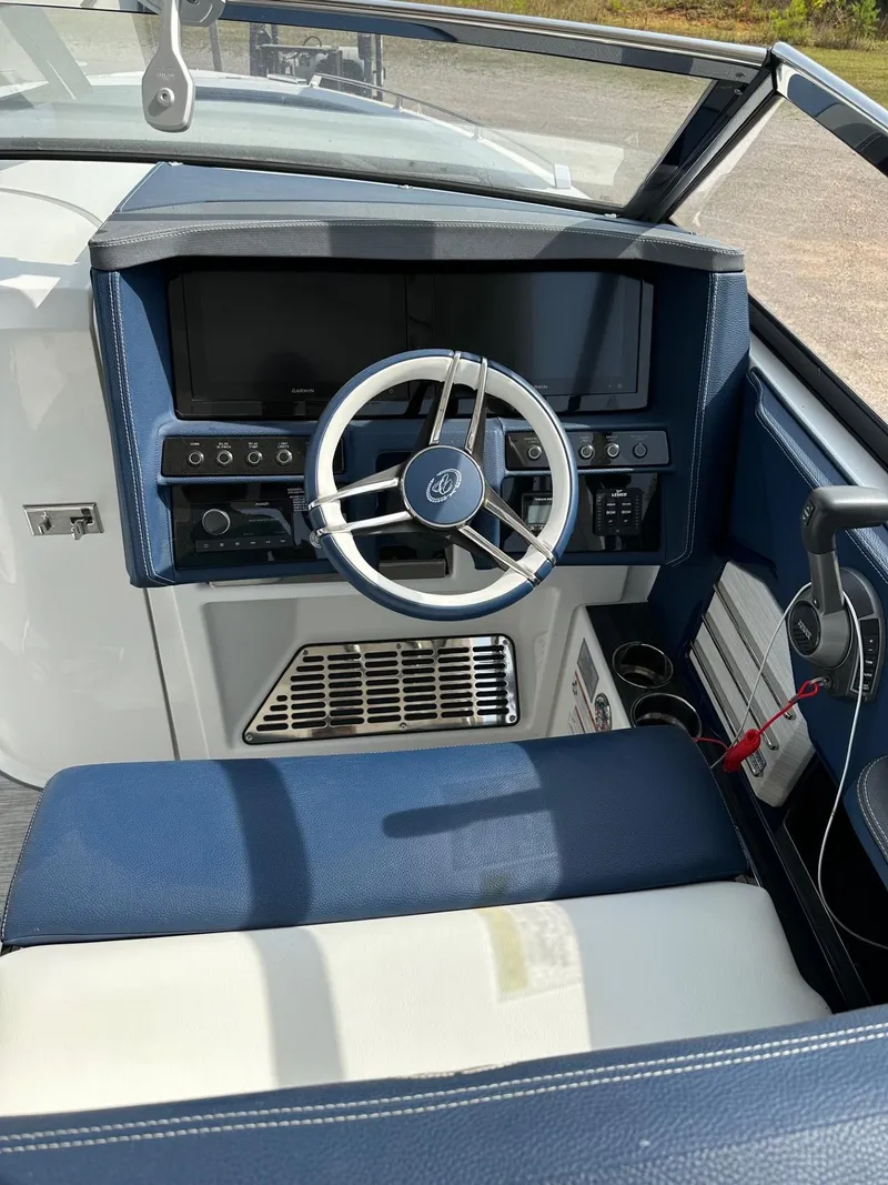 Slide: The Image of 2022 Cobalt A29 boat cockpit with steering wheel and control panel. - 2
