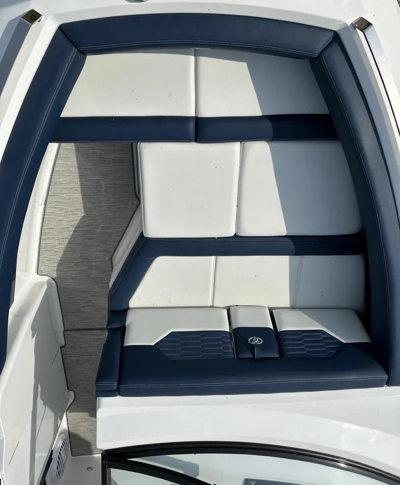 Slide: The Image of 2022 Cobalt A29 boat interior with white and navy seating. - 7