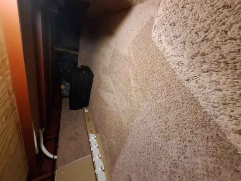 Slide: The Image of Carpeted interior of a 1986 Skipperliner houseboat with storage items. - 14