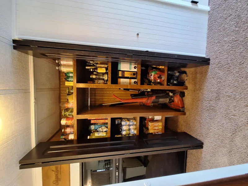 Slide: The Image of Houseboat pantry with shelves stocked with food and cleaning supplies. - 16