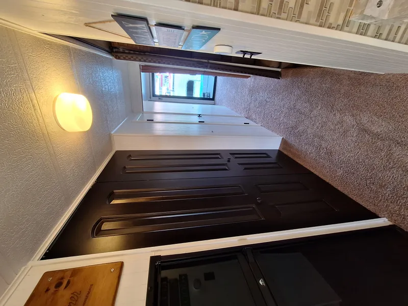 Slide: The Image of Interior hallway of a 1986 Skipperliner houseboat with carpet and modern lighting. - 17