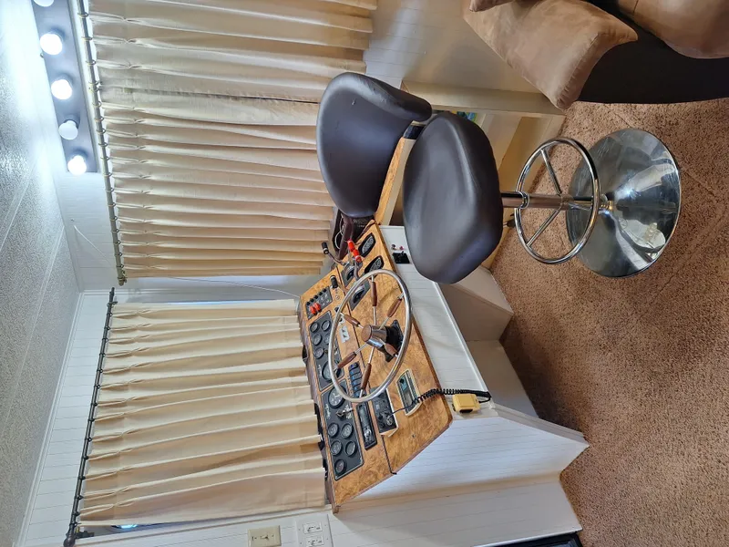 Slide: The Image of 1986 Skipperliner houseboat helm station with control panel and captain's chair. - 20