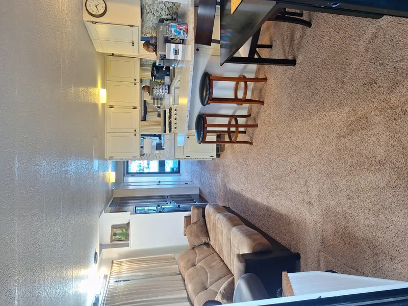 Slide: The Image of Interior of a 1986 Skipperliner houseboat with cozy living area and kitchen. - 22