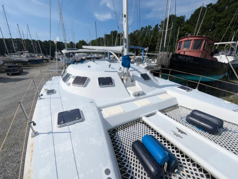 Slide: The Image of Shuttleworth Ocean Cheetah 37 catamaran, 1998 model, docked in a marina with other boats. - 13