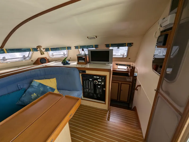 Slide: The Image of Interior of 1998 Shuttleworth Ocean Cheetah 37 catamaran with cozy seating and navigation equipment. - 20