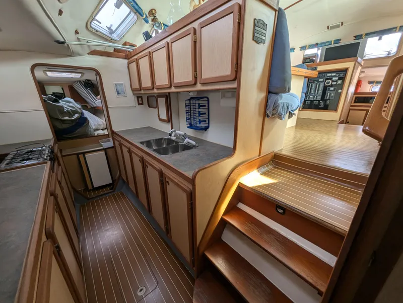 Slide: The Image of Interior of 1998 Shuttleworth Ocean Cheetah 37 yacht, featuring wooden cabinetry and stairs. - 22