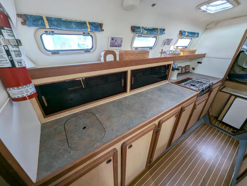 Slide: The Image of Interior of 1998 Shuttleworth Ocean Cheetah 37 catamaran kitchen with countertops and stove. - 23
