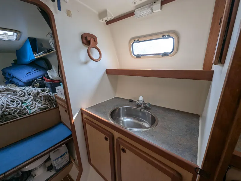 Slide: The Image of Compact bathroom in 1998 Shuttleworth Ocean Cheetah 37 yacht with sink and storage. - 27