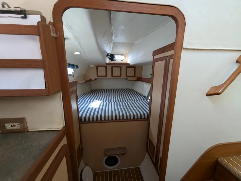 Slide: The Image of Cozy cabin interior of 1998 Shuttleworth Ocean Cheetah 37 with striped bedding and wooden accents. - 29