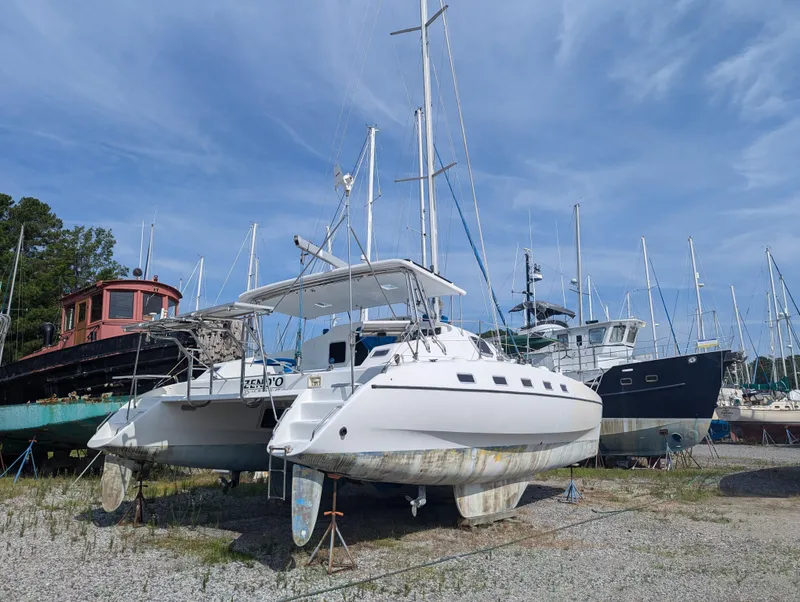Slide: The Image of Shuttleworth Ocean Cheetah 37 catamaran, 1998 model, on dry dock with other boats. - 3