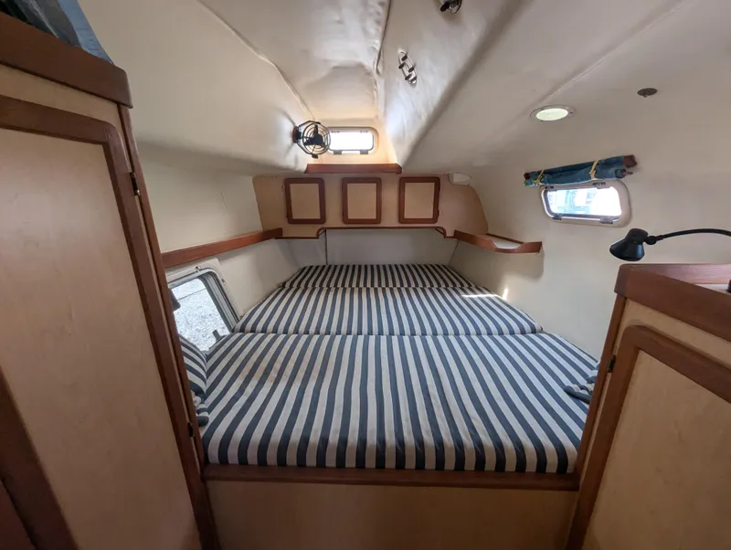 Slide: The Image of Cabin interior of 1998 Shuttleworth Ocean Cheetah 37 with striped bedding and wooden accents. - 31