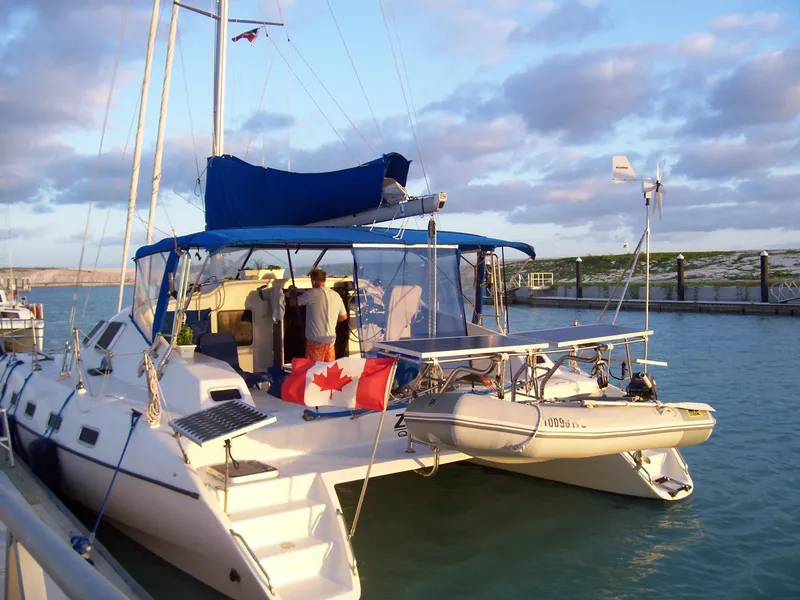 Slide: The Image of Shuttleworth Ocean Cheetah 37 catamaran docked, featuring a Canadian flag and inflatable boat. - 41