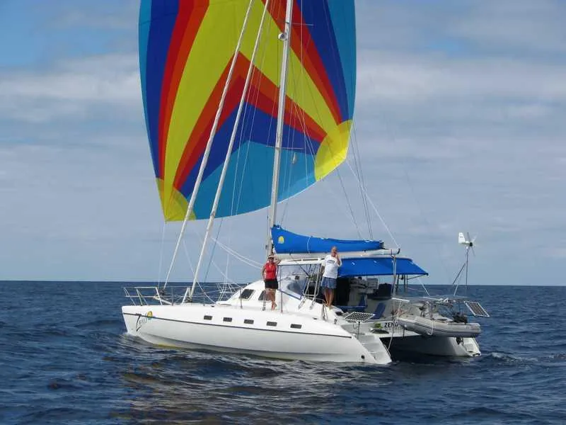Slide: The Image of Sailing catamaran Shuttleworth Ocean Cheetah 37 with colorful spinnaker on open sea, 1998 model. - 43