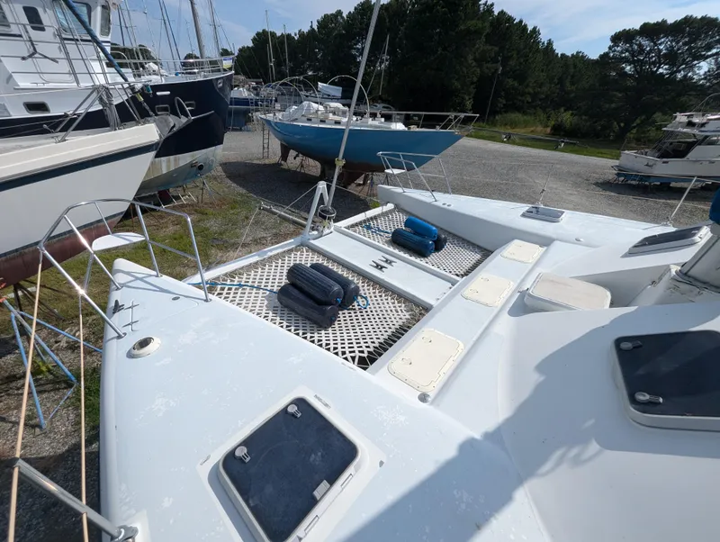Slide: The Image of 1998 Shuttleworth Ocean Cheetah 37 catamaran on land, surrounded by other boats. - 9