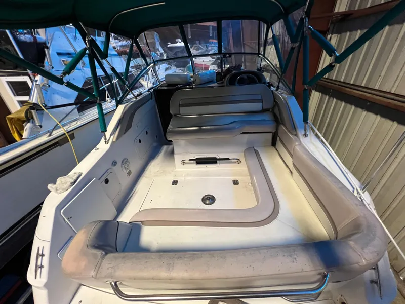 Slide: The Image of 1997 Four Winns 258 Vista boat interior with seating and canopy. - 13