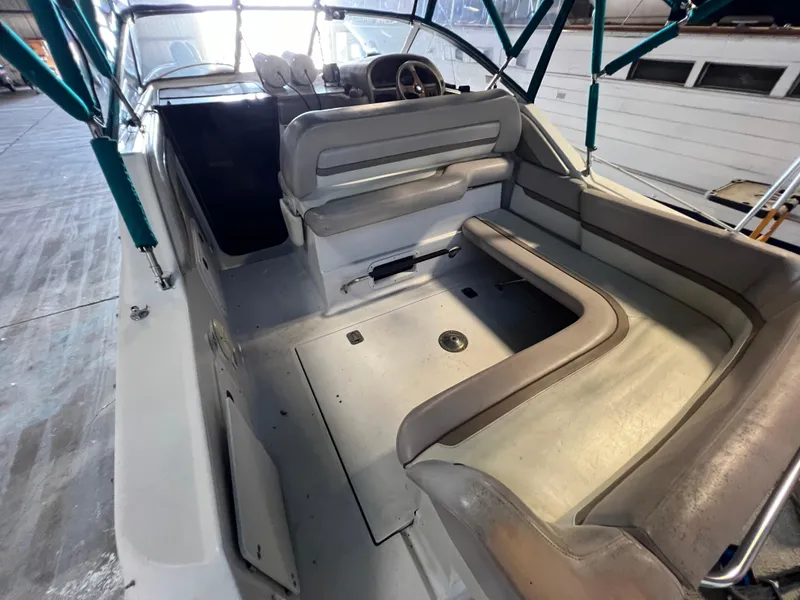 Slide: The Image of 1997 Four Winns 258 Vista boat interior with seating and steering wheel. - 14