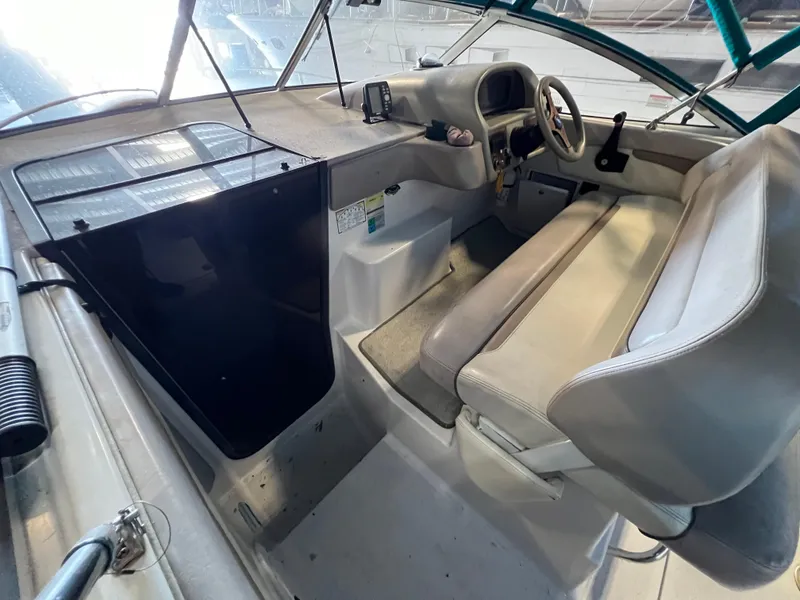 Slide: The Image of 1997 Four Winns 258 Vista boat cockpit with steering wheel and seating. - 16