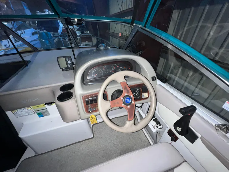 Slide: The Image of 1997 Four Winns 258 Vista boat cockpit with steering wheel and instrument panel. - 18