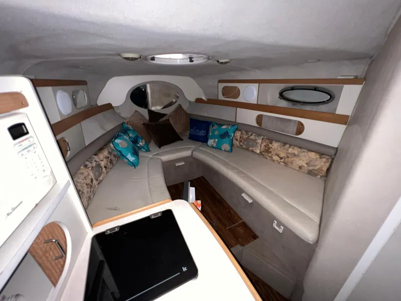 Slide: The Image of 1997 Four Winns 258 Vista boat interior with cozy seating and modern amenities. - 24
