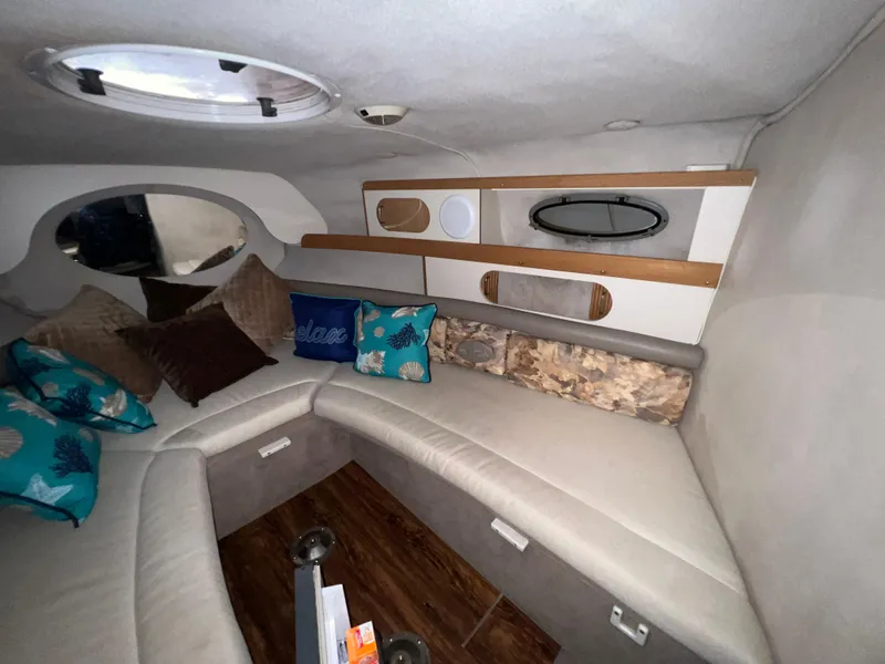 Slide: The Image of Interior cabin of a 1997 Four Winns 258 Vista boat with seating and cushions. - 25
