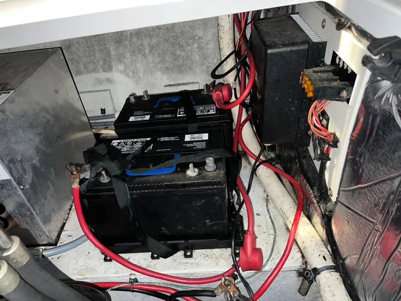 Slide: The Image of 1997 Four Winns 258 Vista boat battery compartment with wiring and electrical components. - 35