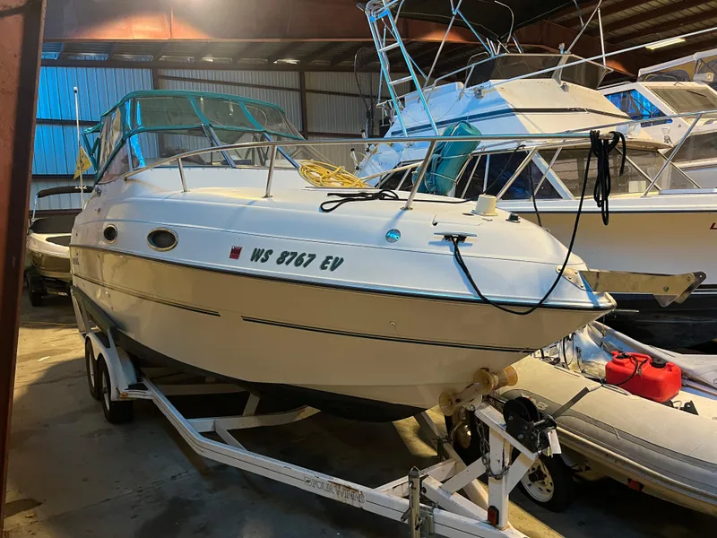 Slide: The Image of 1997 Four Winns 258 Vista boat on trailer in storage facility. - 6