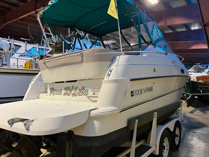 Slide: The Image of 1997 Four Winns 258 Vista boat in indoor storage on a trailer. - 9