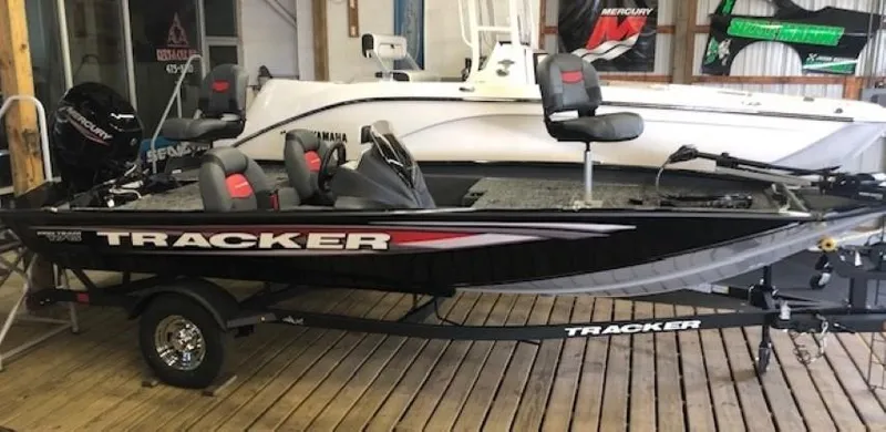 The Image of 2025 Tracker Pro Team 175 TXW fishing boat on display in a showroom. - 0