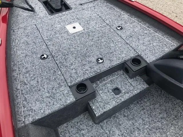 Slide: The Image of 2025 Tracker Pro Team 175 TXW boat interior with gray carpet and storage compartments. - 13