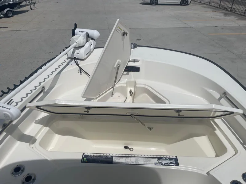 Slide: The Image of 2019 Boston Whaler 210 Montauk boat with open storage compartments. - 12