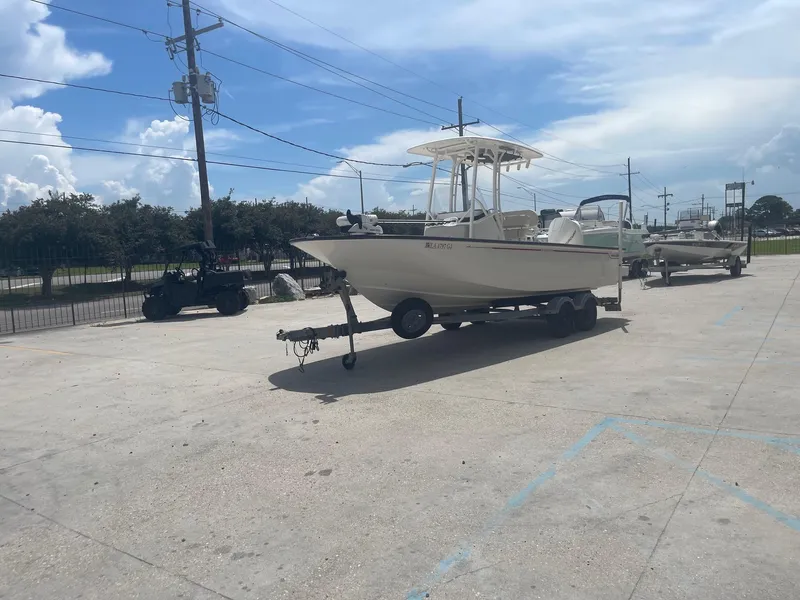 Slide: The Image of 2019 Boston Whaler 210 Montauk boat on trailer in parking lot. - 3