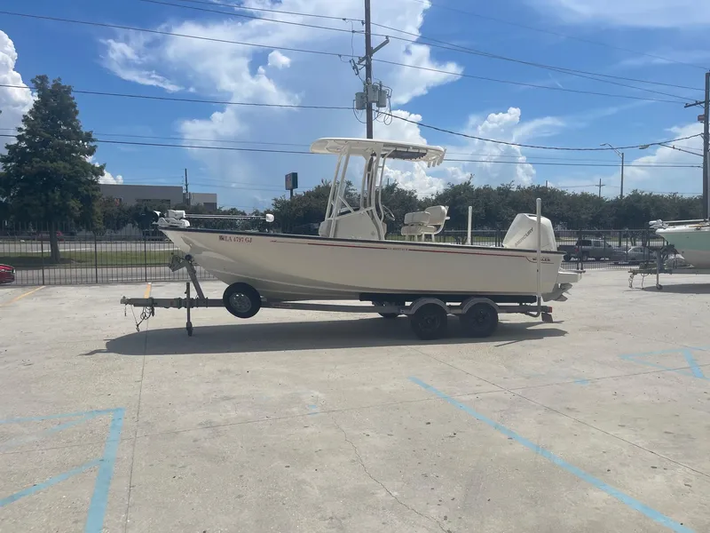Slide: The Image of 2019 Boston Whaler 210 Montauk boat on a trailer in a parking lot. - 4