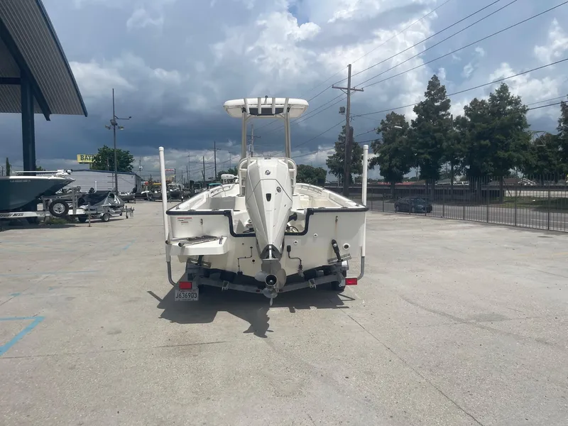 Slide: The Image of 2019 Boston Whaler 210 Montauk boat rear view in a parking lot. - 6