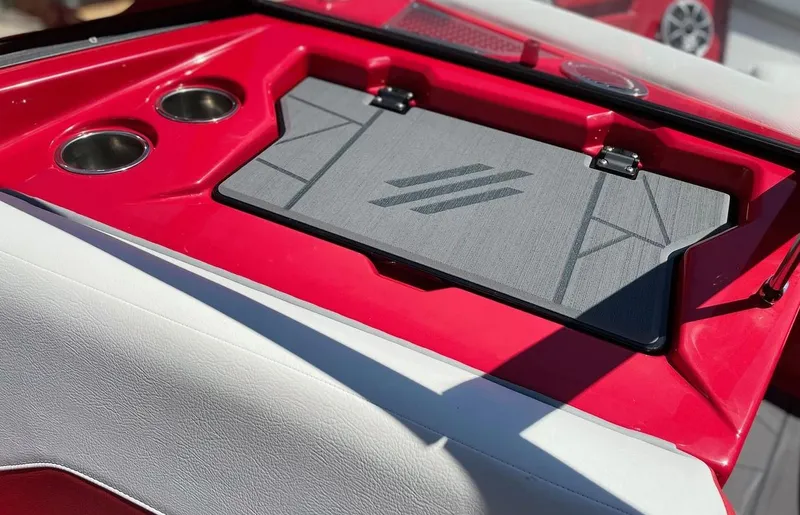 Slide: The Image of 2024 ATX 20 Type-S boat interior with red and white accents, cup holders, and storage compartment. - 12
