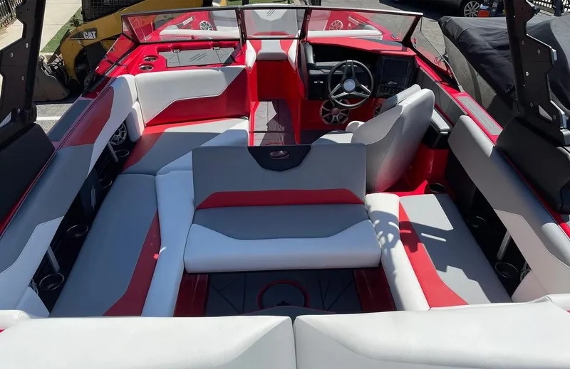 Slide: The Image of 2024 ATX 20 Type-S boat interior with red and gray seating, steering wheel, and dashboard. - 19