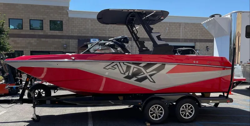 Slide: The Image of 2024 ATX 20 Type-S red and gray boat on trailer in parking lot. - 5