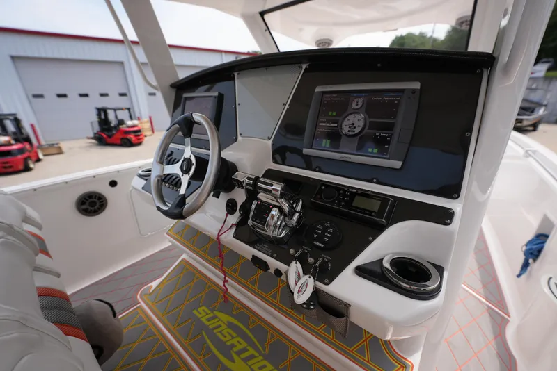 Slide: The Image of 2014 Sunsation 34 CCX boat cockpit with modern navigation system and controls. - 14