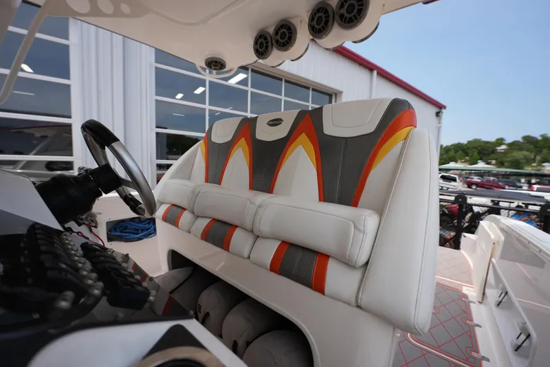 Slide: The Image of 2014 Sunsation 34 CCX boat cockpit with colorful seating and steering wheel. - 18
