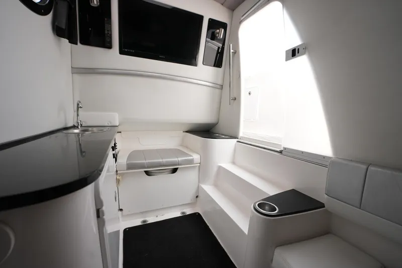 Slide: The Image of Interior of 2014 Sunsation 34 CCX boat with seating, sink, and TV. - 21