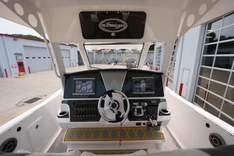 Slide: The Image of 2014 Sunsation 34 CCX boat cockpit with advanced navigation controls and dual screens. - 25