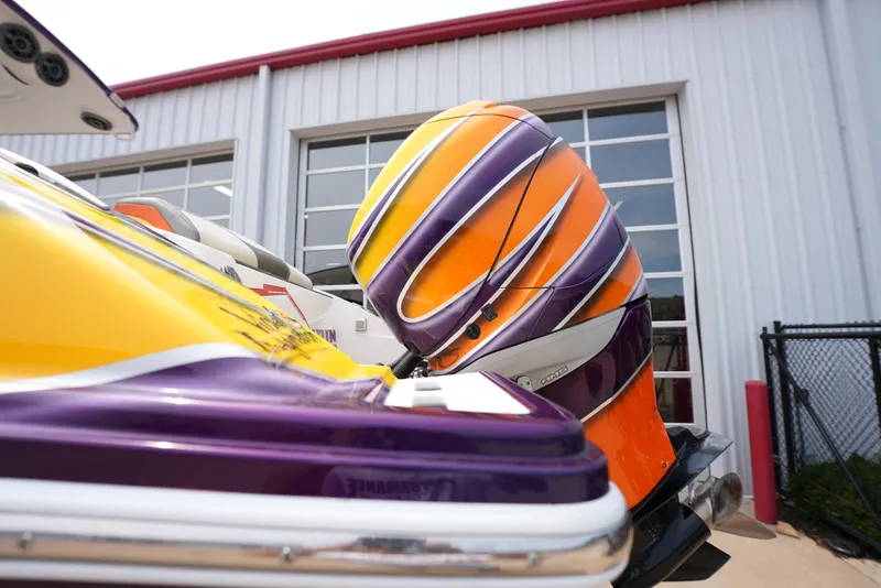 Slide: The Image of 2014 Sunsation 34 CCX boat with vibrant orange and purple design. - 5