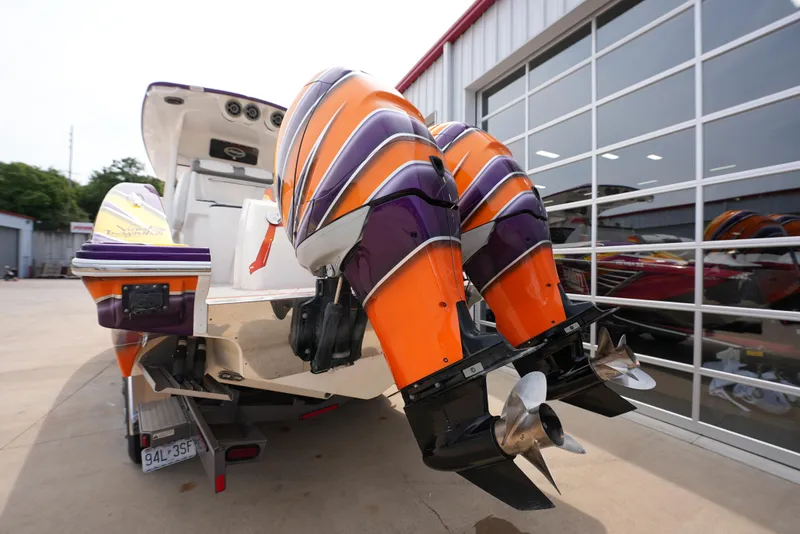 Slide: The Image of 2014 Sunsation 34 CCX boat with vibrant orange and purple outboard motors. - 8