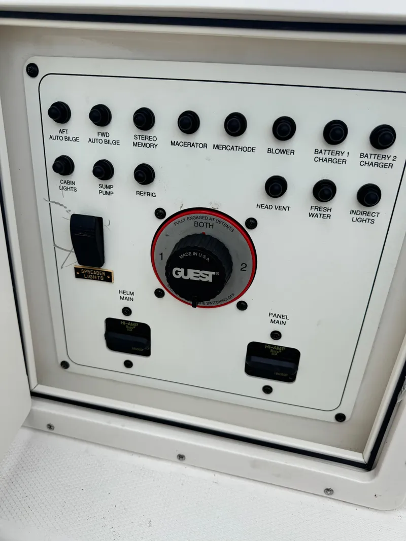 Slide: The Image of Control panel of a 2004 Chaparral Signature 260 boat with various switches and dials. - 12