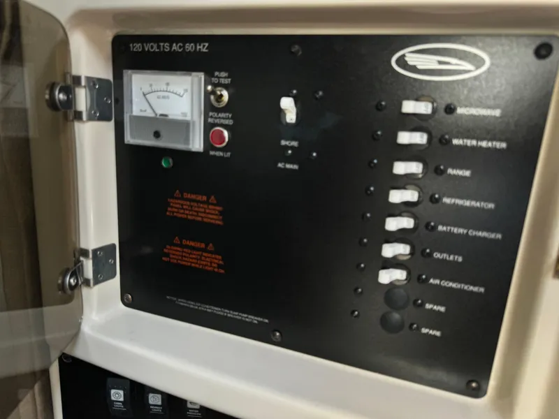Slide: The Image of Electrical control panel of a 2004 Chaparral Signature 260 boat. - 16