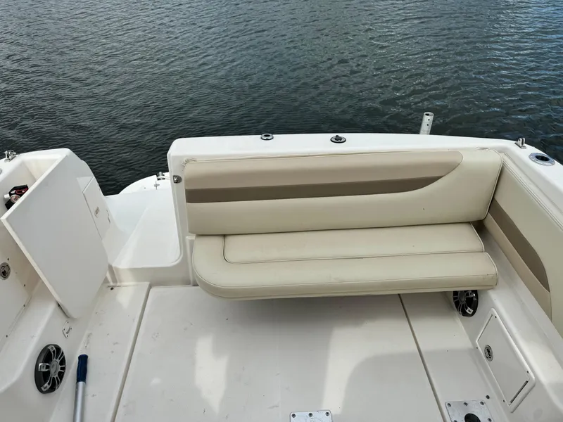 Slide: The Image of 2004 Chaparral Signature 260 boat interior with white seating and water view. - 2